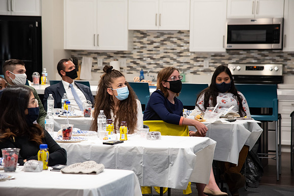 Faculty and Staff of Housing and Student Living gather for an early morning breakfast and an inspirational speaker in the new community center at University Village.