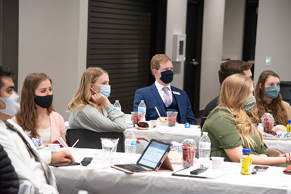 Faculty and Staff of Housing and Student Living gather for an early morning breakfast and an inspirational speaker in the new community center at University Village.