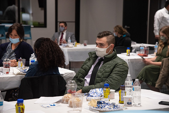 Faculty and Staff of Housing and Student Living gather for an early morning breakfast and an inspirational speaker in the new community center at University Village.