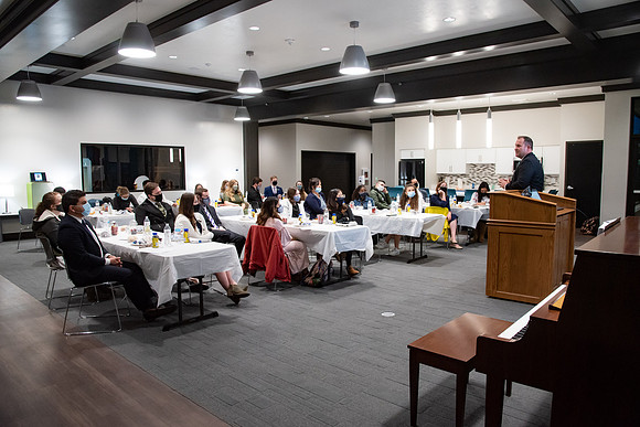 Faculty and Staff of Housing and Student Living gather for an early morning breakfast and an inspirational speaker in the new community center at University Village.