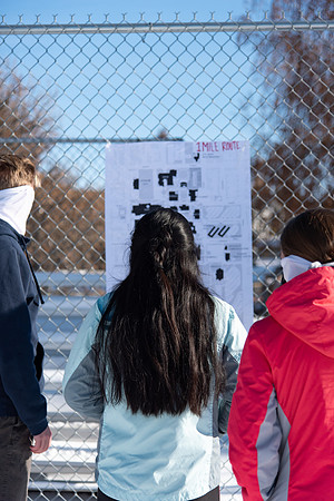 Runners looking at the route they are about to run for the Holiday Color Run.