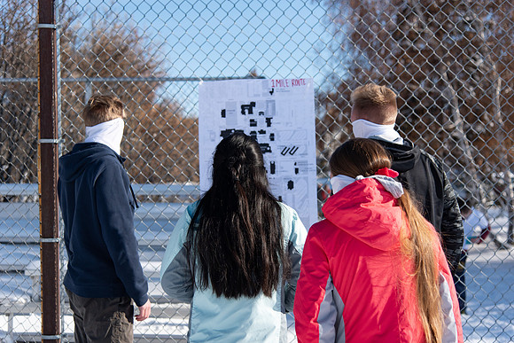 Runners looking at the route they are about to run for the Holiday Color Run.
