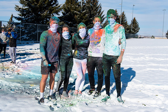 Runners at the Holiday Color Run covered in chalk ready to start the race.