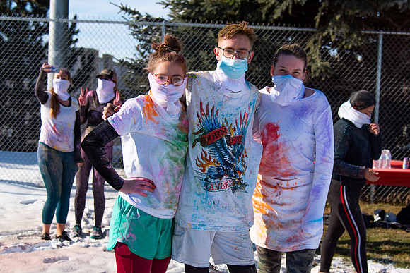 Runners at the Holiday Color Run covered in chalk ready to start the race.