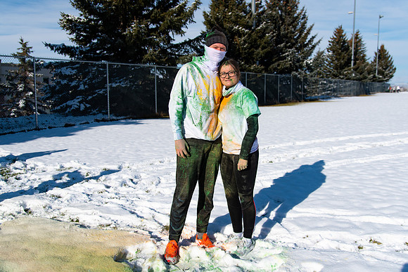 Runners at the Holiday Color Run covered in chalk ready to start the race.