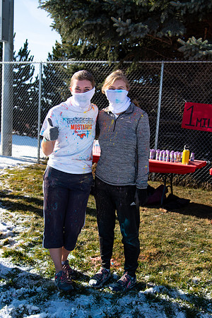 Runners at the Holiday Color Run covered in chalk ready to start the race.