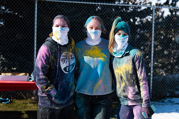 Runners at the Holiday Color Run covered in chalk ready to start the race.