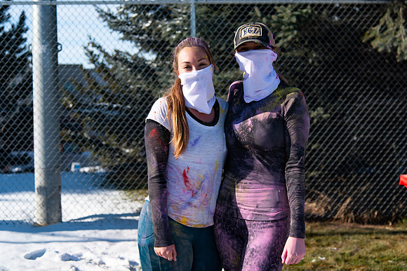 Runners at the Holiday Color Run covered in chalk ready to start the race.
