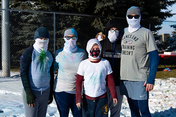 Runners at the Holiday Color Run covered in chalk ready to start the race.