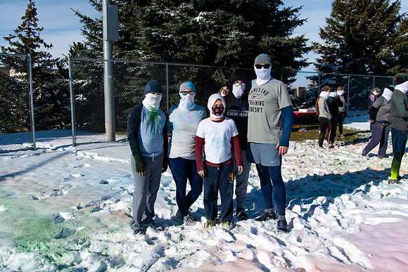 Runners at the Holiday Color Run covered in chalk ready to start the race.