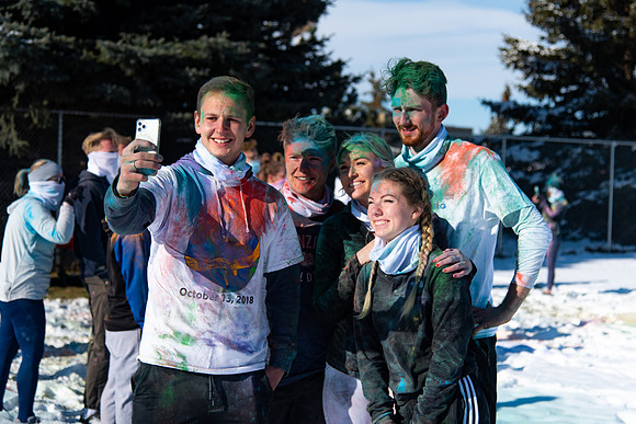 Runners at the Holiday Color Run covered in chalk ready to start the race.