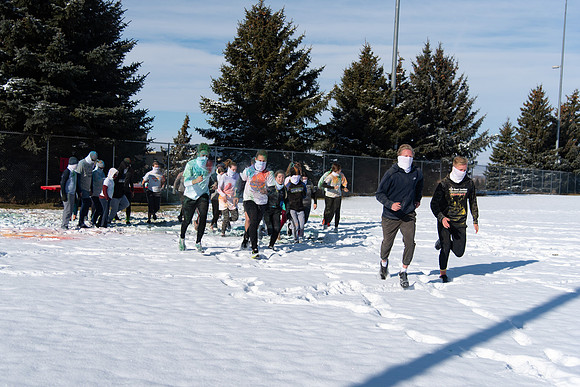 Students and their families running the Holiday Color Run.