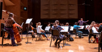 String instruments practice in the Barrus Concert Hall under the direction of Robert Tueller.