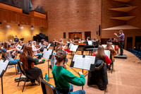String instruments practice in the Barrus Concert Hall under the direction of Robert Tueller.