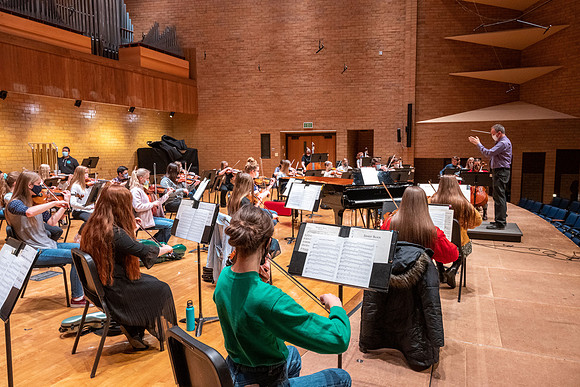 String instruments practice in the Barrus Concert Hall under the direction of Robert Tueller.