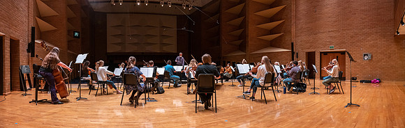 String instruments practice in the Barrus Concert Hall under the direction of Robert Tueller.