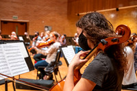 String instruments practice in the Barrus Concert Hall under the direction of Robert Tueller.