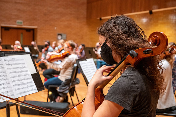 String instruments practice in the Barrus Concert Hall under the direction of Robert Tueller.