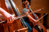String instruments practice in the Barrus Concert Hall under the direction of Robert Tueller.