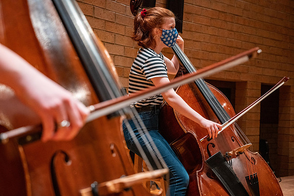 String instruments practice in the Barrus Concert Hall under the direction of Robert Tueller.