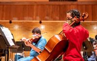String instruments practice in the Barrus Concert Hall under the direction of Robert Tueller.