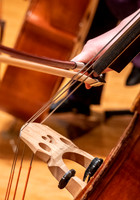 String instruments practice in the Barrus Concert Hall under the direction of Robert Tueller.