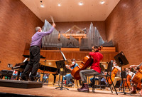 String instruments practice in the Barrus Concert Hall under the direction of Robert Tueller.