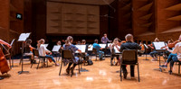 String instruments practice in the Barrus Concert Hall under the direction of Robert Tueller.