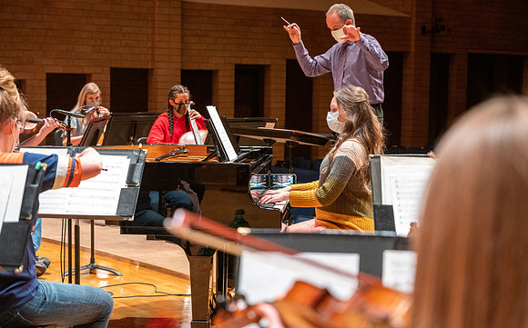 String instruments practice in the Barrus Concert Hall under the direction of Robert Tueller.