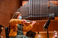 String instruments practice in the Barrus Concert Hall under the direction of Robert Tueller.