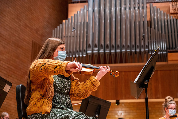 String instruments practice in the Barrus Concert Hall under the direction of Robert Tueller.