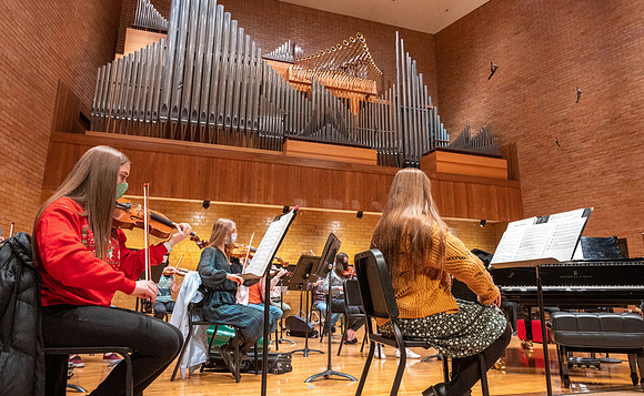 String instruments practice in the Barrus Concert Hall under the direction of Robert Tueller.