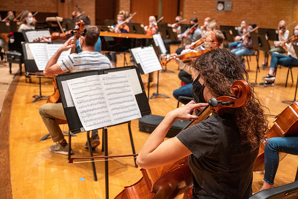 String instruments practice in the Barrus Concert Hall under the direction of Robert Tueller.