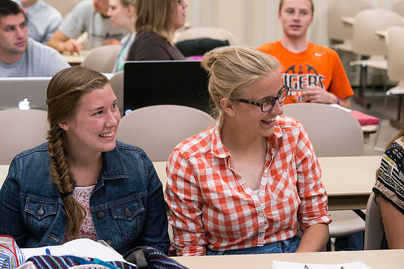 Students in Brother Adamson's Political Science class laugh at a remark made.