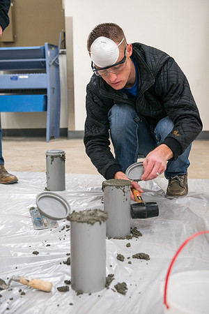 Civil engineering students work with different mixtures of cement to make a light, yet durable, cement that will be the building material for a canoe.