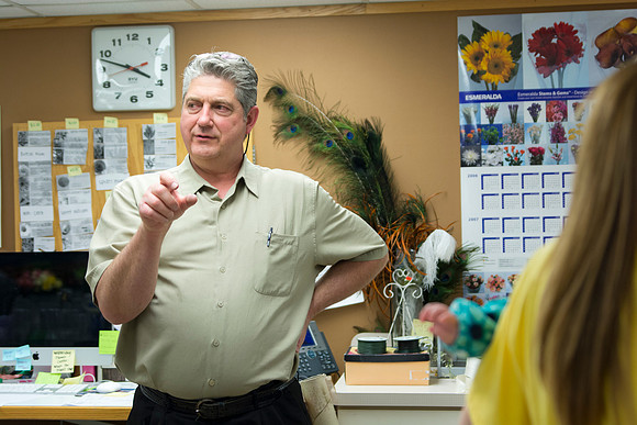 Horticulture students prepare for a semester review fashion show that will show their floral designs as well. Brother Romney leads the students along with other instructors.