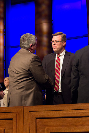 BYU-Idaho counseler Bruce Blanchard greets and congratulates newly announced President Clark Gilbert. Taken by Erik Hill