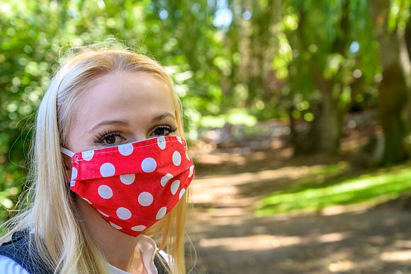 Student volunteers show the way to stay safe during this COVID 19 pandemic by social distancing, following pathway arrows and proper wearing of masks .