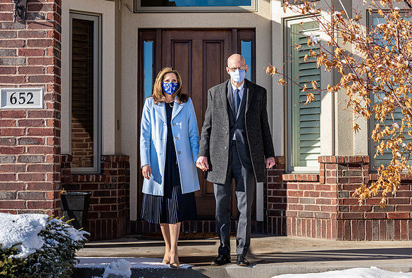 President and Sister Eyring leaving their home with masks on.