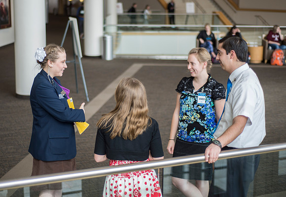 Ushers meet in groups before devotional to talk about their responsibilities.