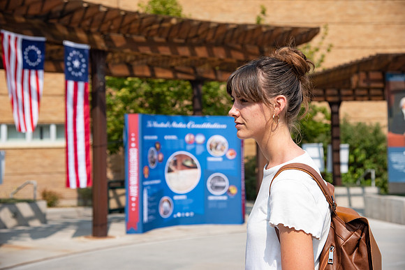 Student reading a poster about the constitution.