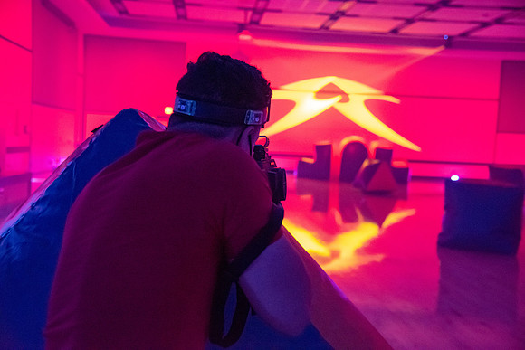 Students play laser tag on campus with masks on.