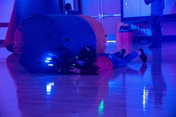 Students play laser tag on campus with masks on.