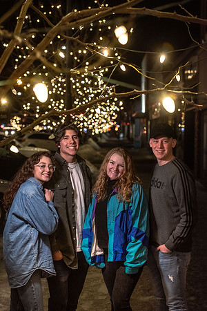 A group of students enjoy the lights on Main St. and Center St.