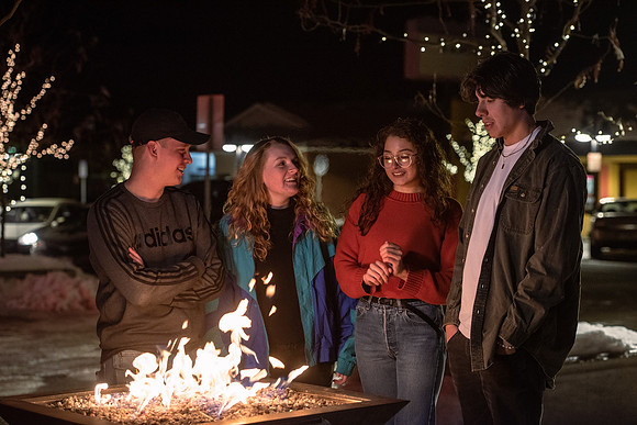 A group of students enjoy the lights on Main St. and Center St.