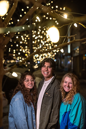 A group of students enjoy the lights on Main St. and Center St.
