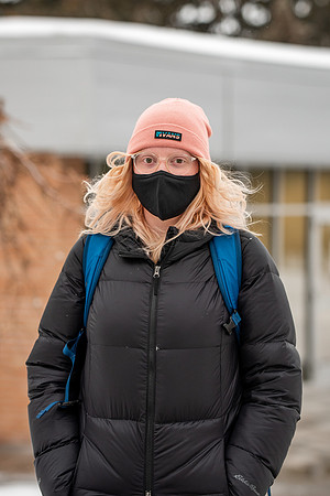 Students smiling with masks around campus on a snowy afternoon at BYUI during the Covid pandemic.