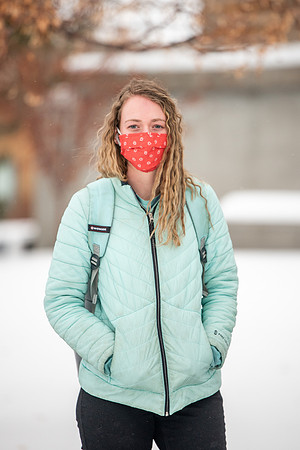 Students smiling with masks around campus on a snowy afternoon at BYUI during the Covid pandemic.