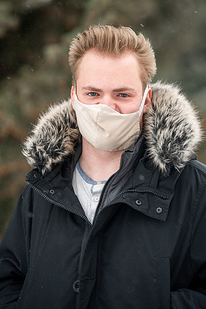 Students smiling with masks around campus on a snowy afternoon at BYUI during the Covid pandemic.