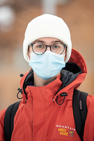 Students smiling with masks around campus on a snowy afternoon at BYUI during the Covid pandemic.